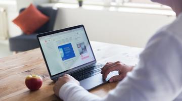 A visual of a man on a laptop